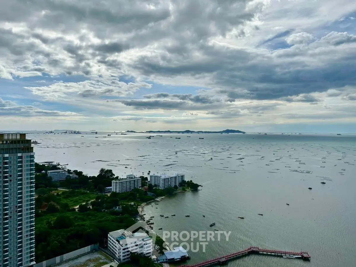 Stunning ocean view from high-rise building with expansive sky and distant islands.
