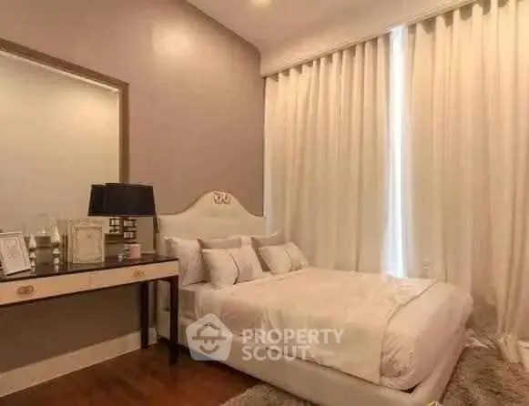 Elegant bedroom with plush bed, stylish decor, and soft lighting for a cozy ambiance.