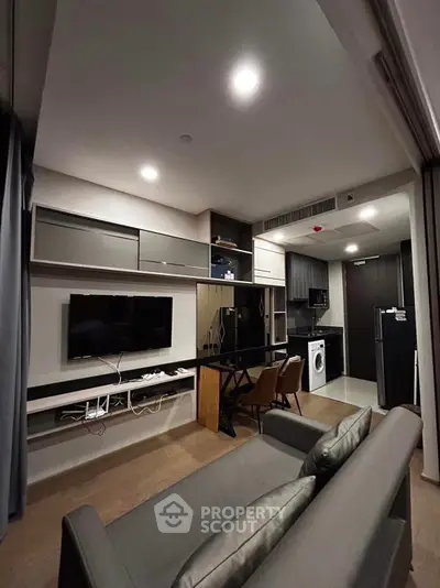 Modern living room with sleek furniture and integrated kitchen appliances