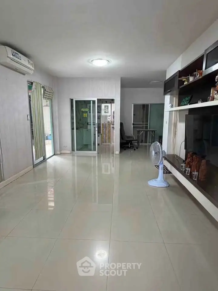 Spacious living room with modern decor and large windows for natural light.