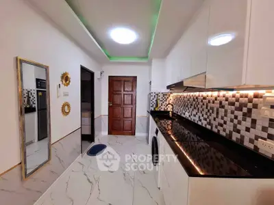 Modern kitchen with sleek black countertops and stylish backsplash