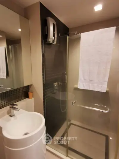 Modern bathroom with glass shower and sleek fixtures