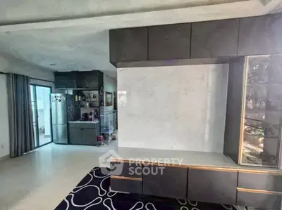 Modern living room with sleek cabinetry and open kitchen layout