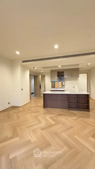 Spacious modern kitchen with open layout and elegant wooden flooring