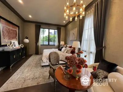 Luxuriously appointed bedroom with elegant decor, plush furnishings, and a serene ambiance, featuring a cozy sitting area and abundant natural light.