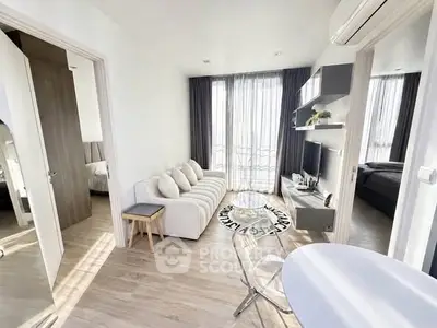 Modern living room with natural light, stylish furniture, and open layout in a contemporary apartment.