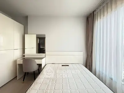 Modern bedroom with minimalist design, featuring a bed, wardrobe, and study desk by a large window.