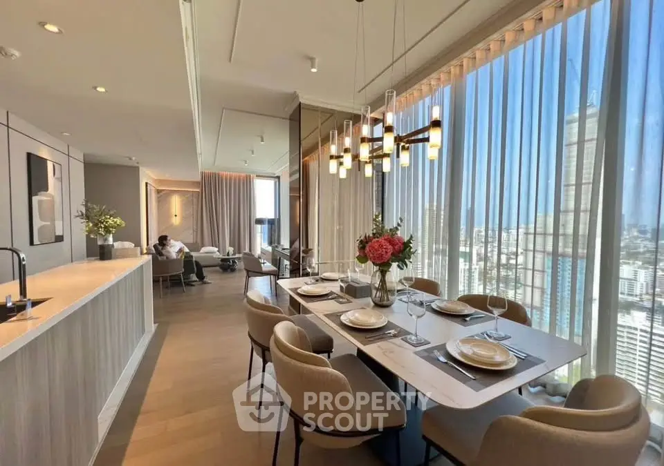 Luxurious open-plan living and dining area with stunning city views and elegant decor.