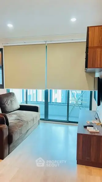 Modern living room with cozy sofa and balcony view in a stylish apartment.