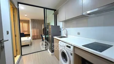 Modern apartment kitchen with washing machine and sleek design