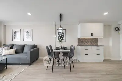 Modern living room with stylish dining area and sleek kitchen cabinets