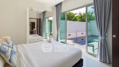 Luxurious bedroom with pool view and elegant decor in modern villa