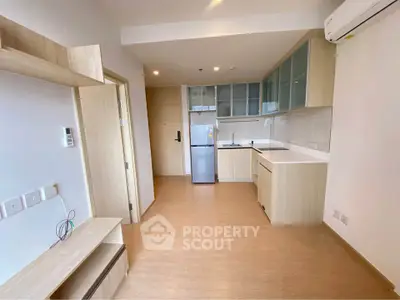 Modern kitchen with sleek cabinetry and integrated appliances in a bright apartment.