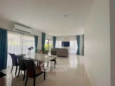Spacious modern living room with elegant dining area and natural light
