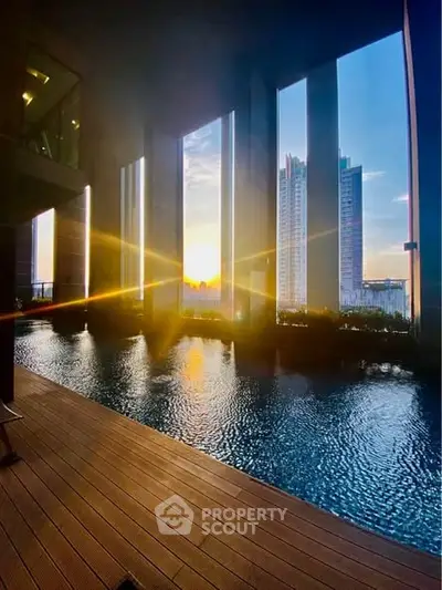 Luxurious high-rise pool with stunning sunset city view, perfect for urban living enthusiasts.
