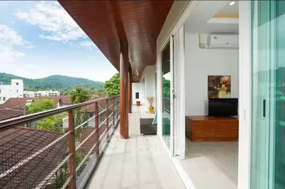 Spacious balcony with scenic view and modern interior access in luxury apartment.
