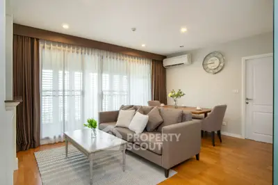 Spacious living room with modern decor and natural light in a stylish apartment