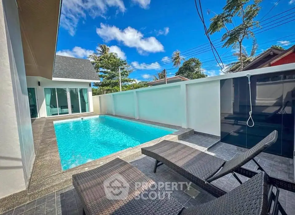 Luxurious private pool area with modern design and sun loungers, perfect for relaxation and entertainment.