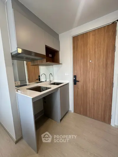 Modern kitchen with sleek design and open layout, featuring built-in appliances and stylish cabinetry.