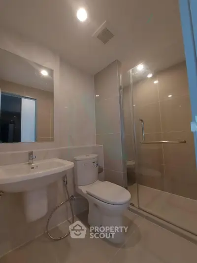 Modern bathroom with sleek fixtures and glass shower enclosure