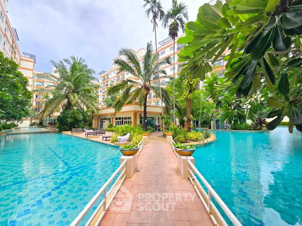 Luxurious resort-style pool area with lush greenery and modern architecture.