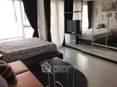 Modern bedroom with mirrored wardrobe and stylish decor in a cozy apartment.