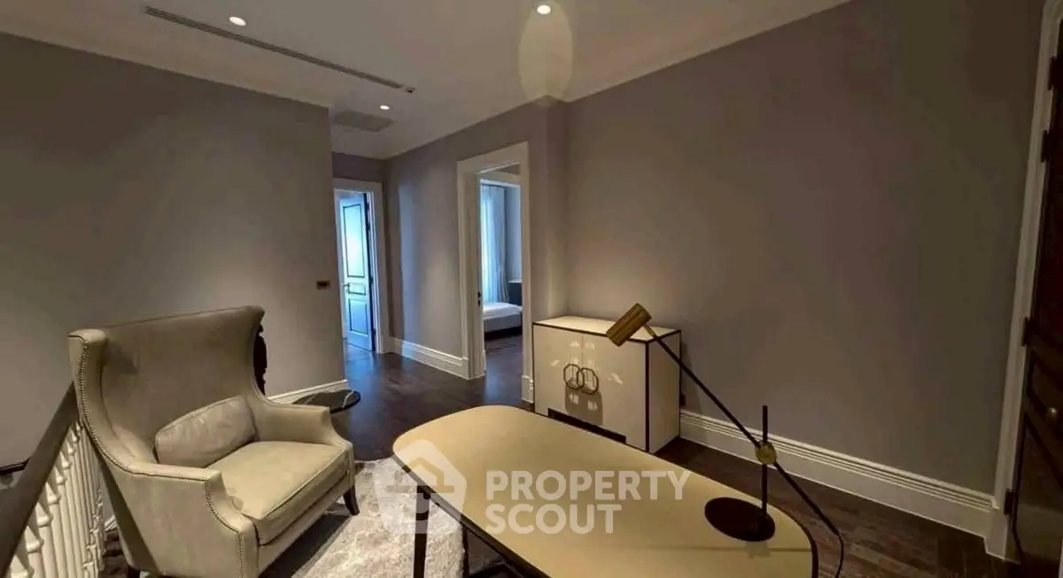 Elegant study room with modern desk and cozy armchair in a stylish home interior.