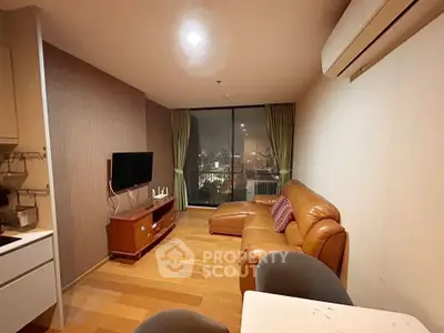 Modern living room with leather sofa and city view, featuring a wall-mounted TV and wooden flooring.