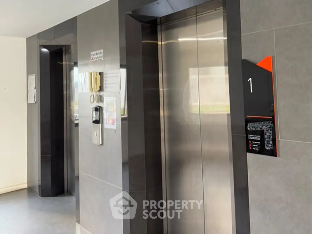 Modern elevator lobby with sleek design and stainless steel doors