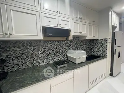 Modern kitchen with sleek cabinetry and stylish backsplash