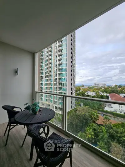 Spacious balcony with stunning city view in modern high-rise apartment