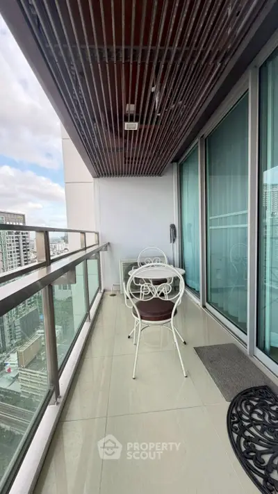 Spacious balcony with city view, perfect for relaxation and outdoor dining.