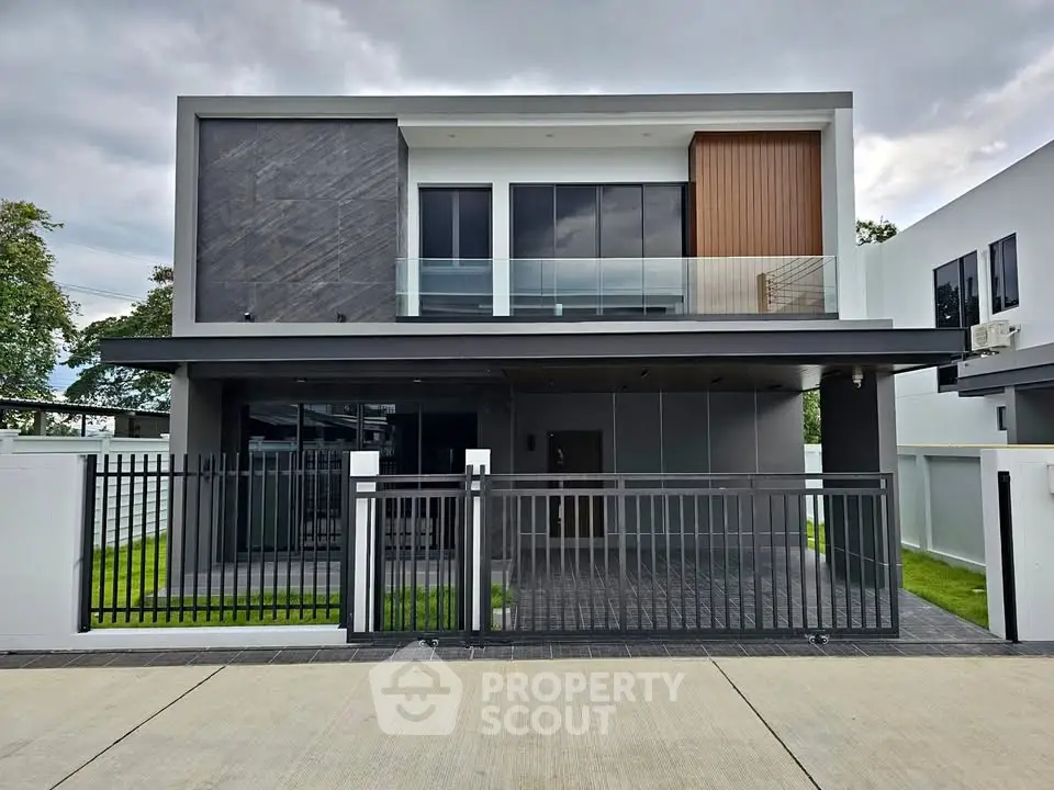 Modern two-story house with sleek design and gated entrance