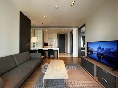 Modern living room with sleek furniture and open kitchen layout in luxury apartment
