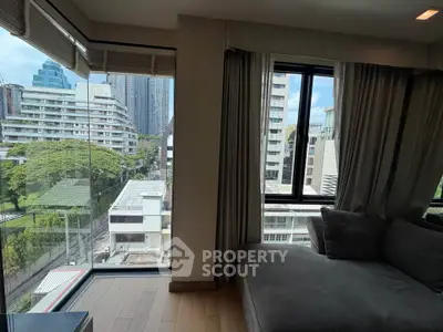 Spacious corner unit with panoramic city views and cozy seating area.
