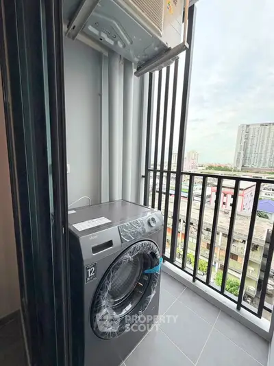 Modern apartment balcony with washing machine and city view