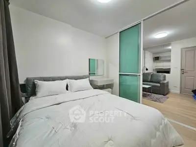 Modern bedroom with sliding glass door leading to cozy living area