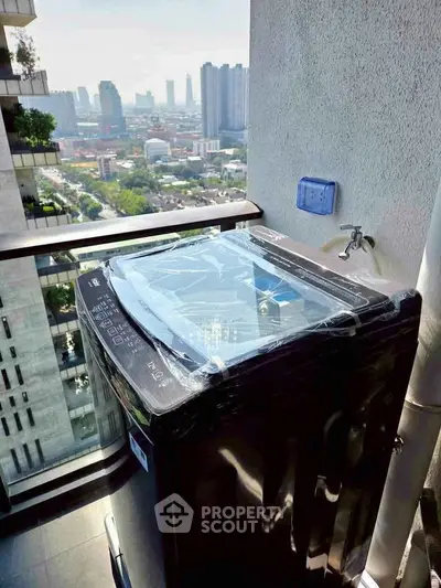 Modern balcony with washing machine and stunning city view in high-rise apartment.