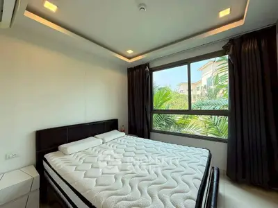 Spacious bedroom with large window and modern design in a luxury apartment.