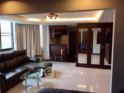Spacious living room with modern furniture and large windows in a stylish apartment.