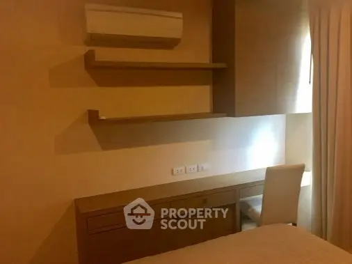 Cozy bedroom with built-in desk and air conditioning