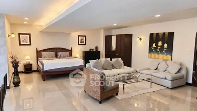 Spacious open-plan living room with elegant decor and cozy seating area, perfect for modern living.