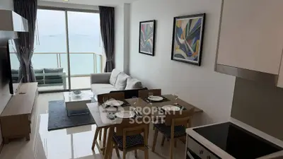 Modern living room with ocean view and stylish decor in a high-rise apartment.