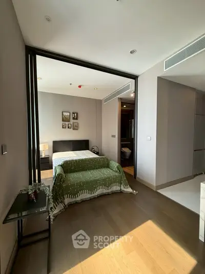 Modern bedroom with stylish decor and natural light in a contemporary apartment.
