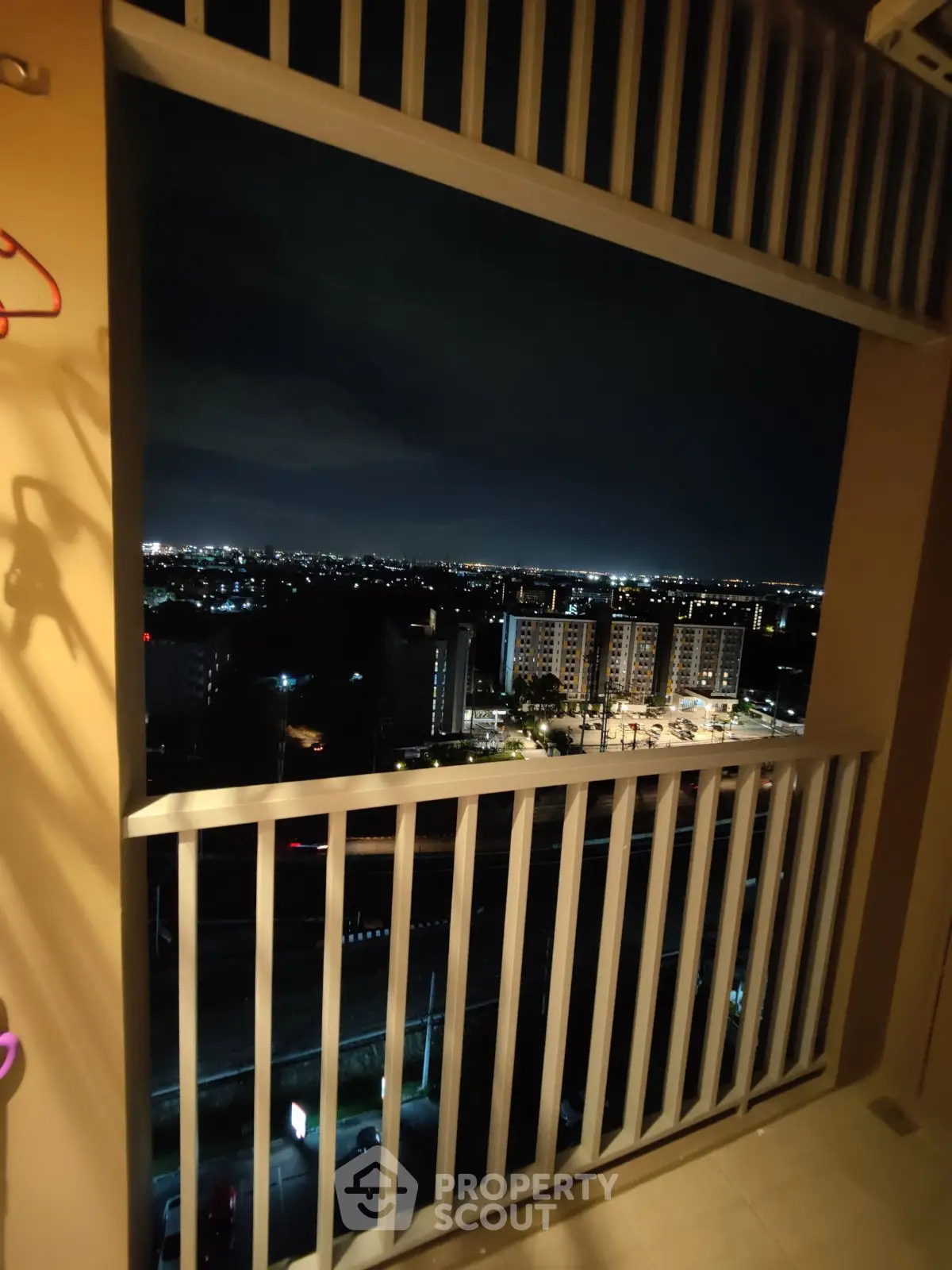 Stunning night cityscape view from a high-rise balcony, perfect for urban living.