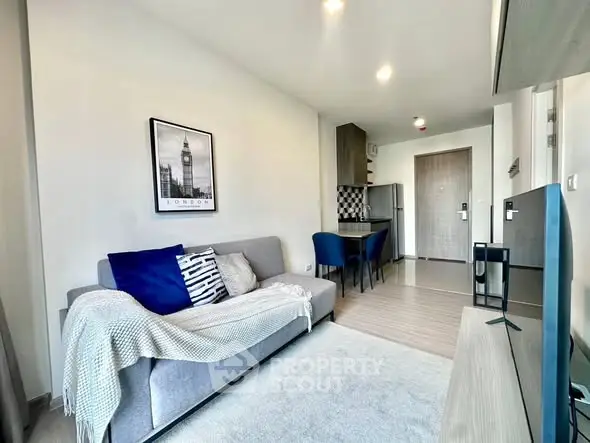 Modern living room with cozy sofa and stylish decor in open-plan apartment.