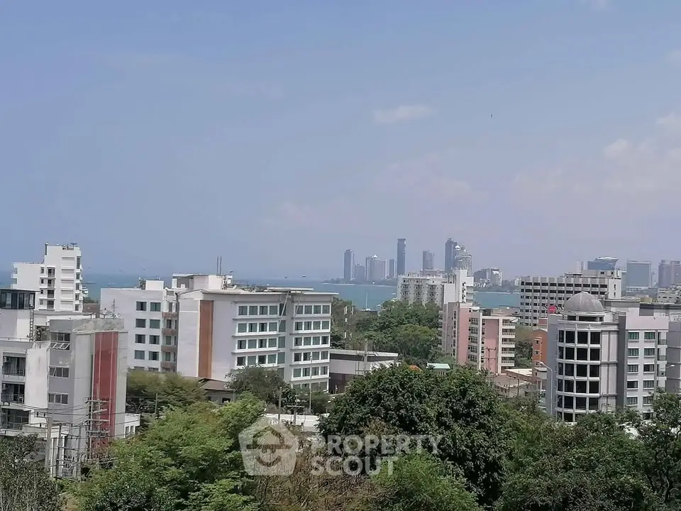 Stunning cityscape view with modern buildings and ocean backdrop