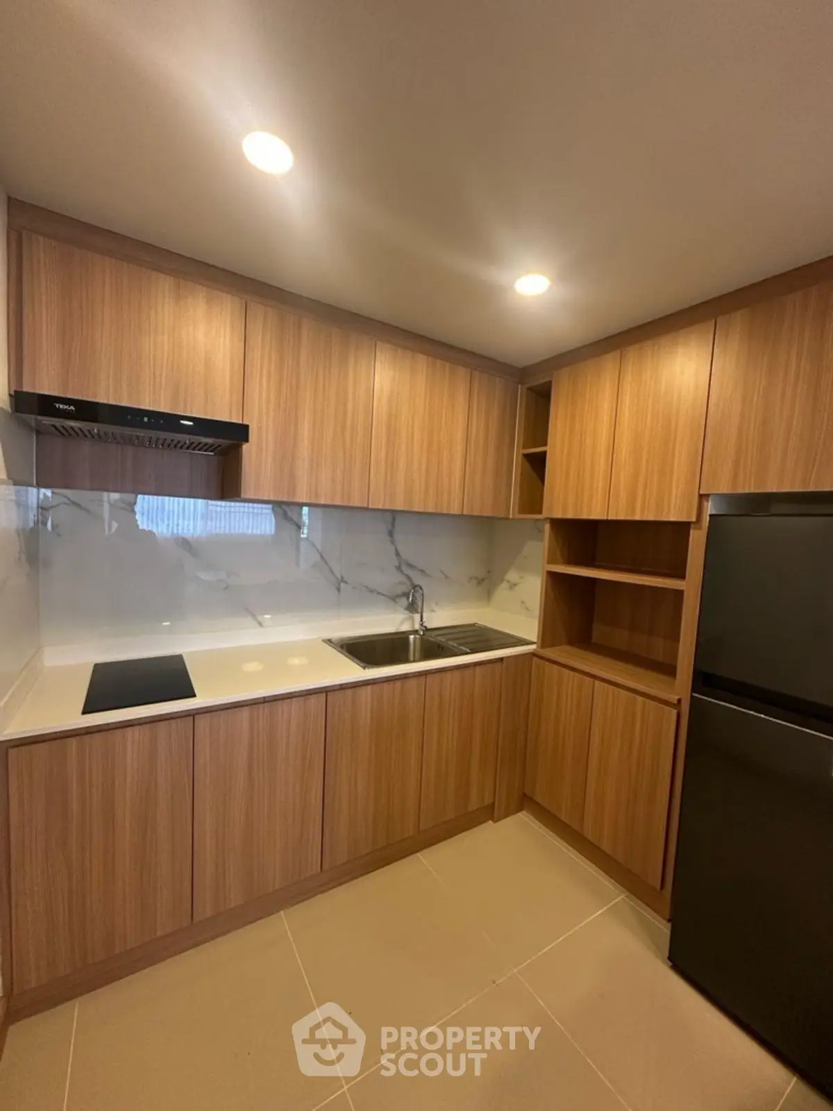 Modern kitchen with sleek wooden cabinets and integrated appliances