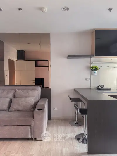 Modern living room with sleek bar counter and plush gray sofa