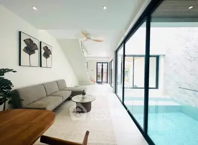 Modern living room with pool view and elegant decor